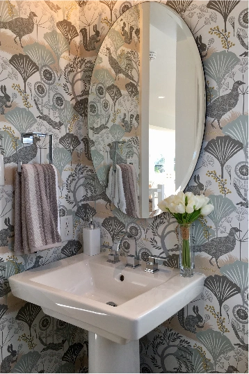 Modern Bathroom with Patterned Wallpaper and Oval Mirror in Dubai
