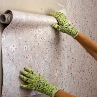 Technician installing wallpaper efficiently